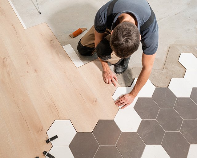 a man fixing tile