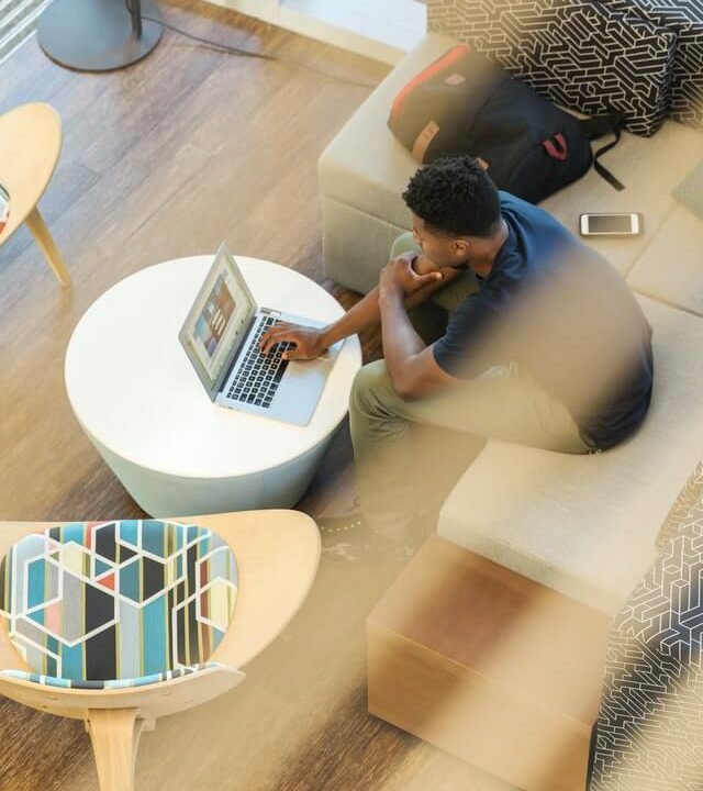 a man sitting with laptop